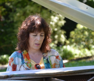 Mary Fineman playing piano outside