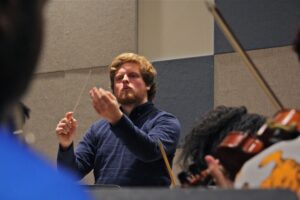 Davey Hiester conducts the student-led Center City Chamber Orchestra during rehearsal at Settlement Music School